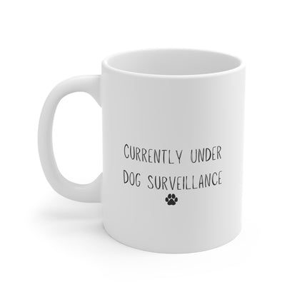 11oz white mug with “Currently Under Dog Surveillance” quote design by Rudy & Co.