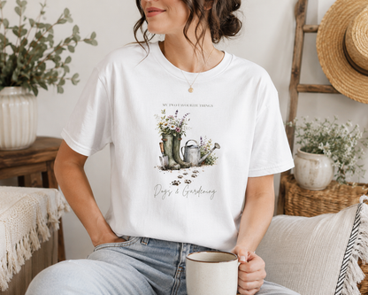 Person wearing a white t-shirt with a graphic design and text, sitting on a couch in a cozy room.